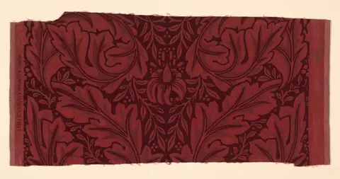 Scrolling acanthus leaves in green, gold, and rust