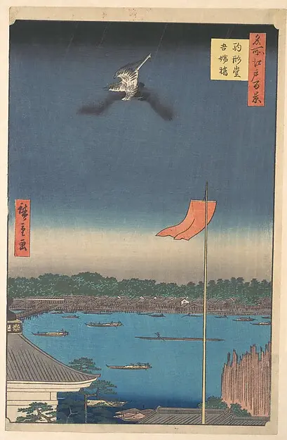 A bird flying in a dark blue sky above a broad river with small boats