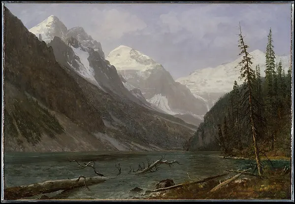 Snow-capped mountains above a still lake with evergreens on the right