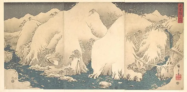 Wide view of pale snow-covered mountain peaks with a thin blue band below