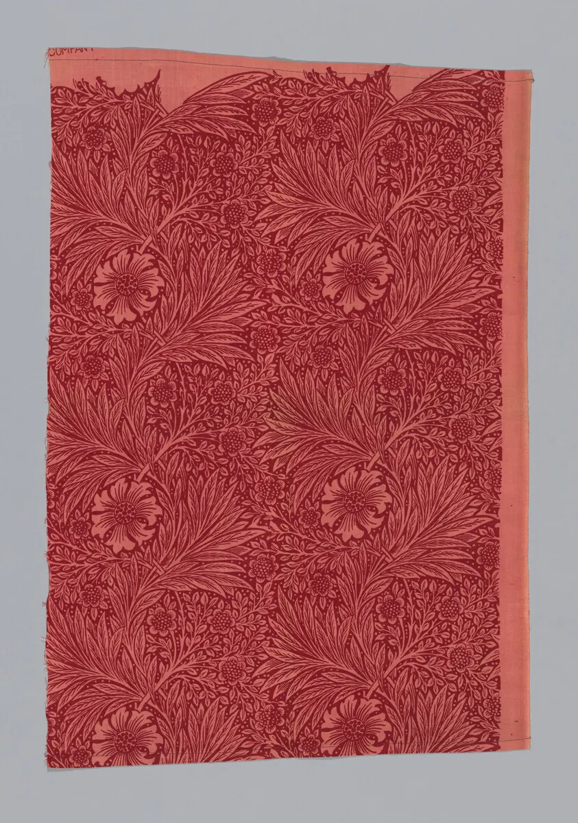 A repeating pattern of marigold flowers in indigo, gold, and rust