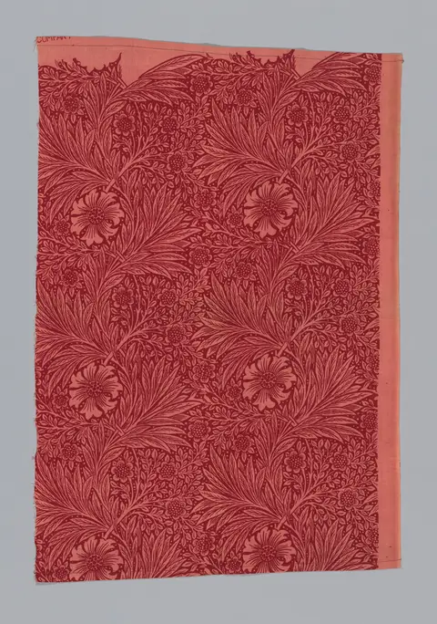 A repeating pattern of marigold flowers in indigo, gold, and rust