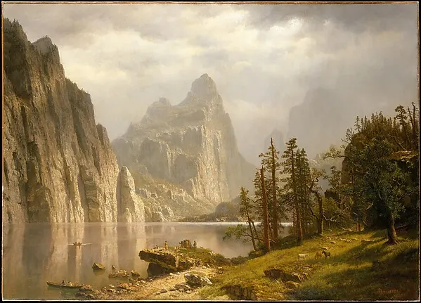 Sunlit granite cliffs and pine trees above a calm river in Yosemite Valley