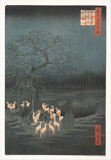 Foxes with small floating flames gathered under a bare tree at night