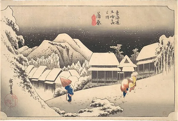 Travelers walking through a snow-covered village under a dark night sky